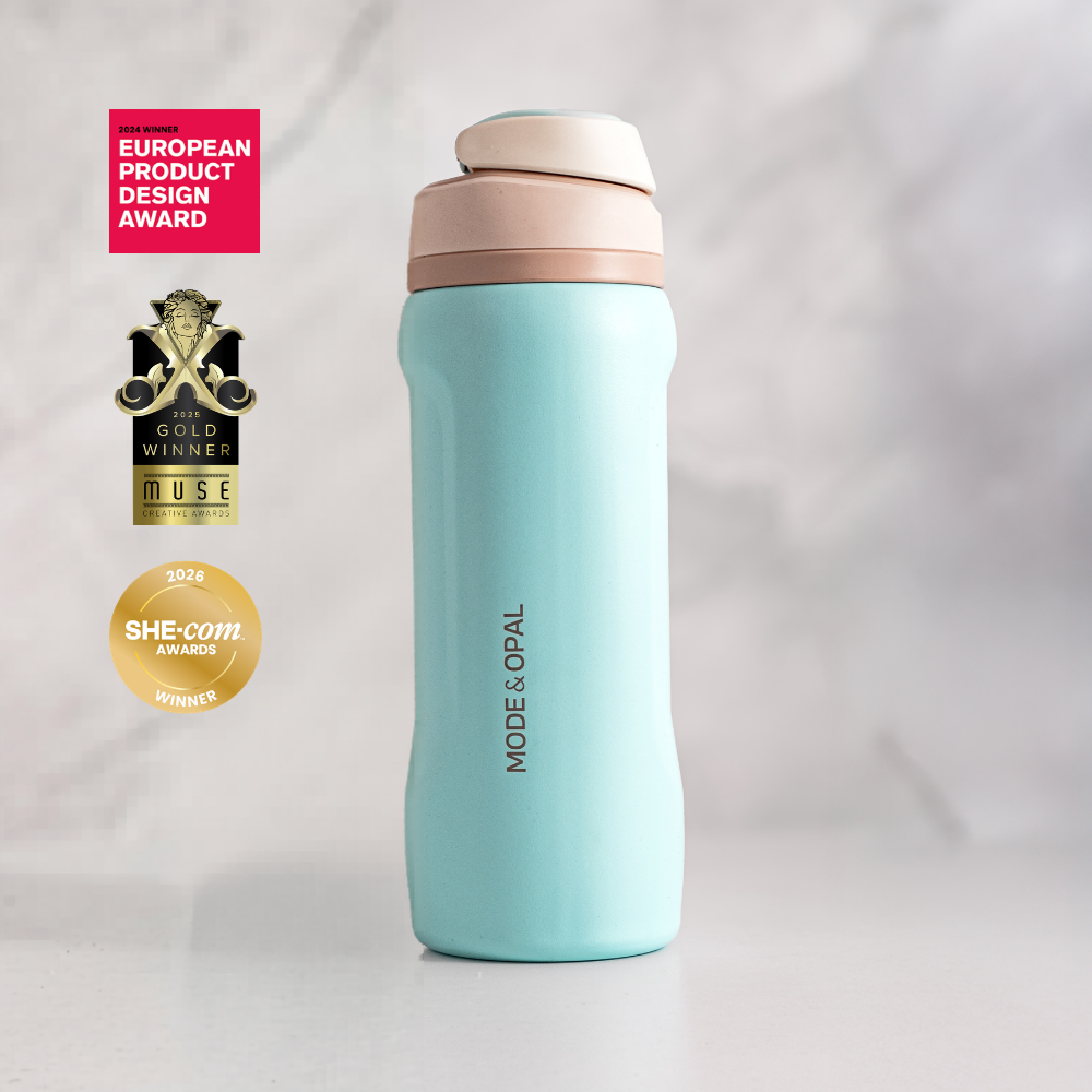 Powder Blue Mode & Opal drink bottle on a windowsill, shown with its design award badges.
