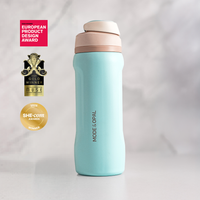 Powder Blue Mode & Opal drink bottle on a windowsill, shown with its design award badges.